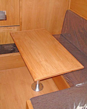 Forward bedroom showing day cabin setup with removable table for making into double bed