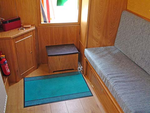 This view shows the L shape option on teh GEM narrowboat which can be used as day cabin or left made up as double bed