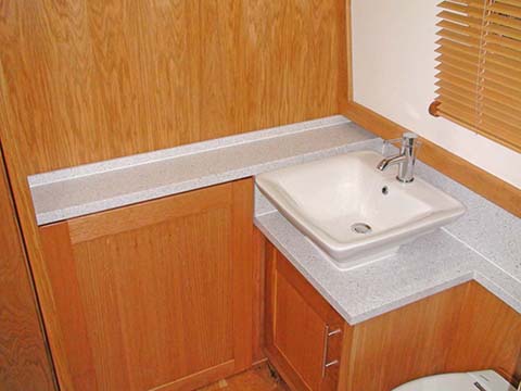 Narrowboat shower cabin with Corian vanity surfaces