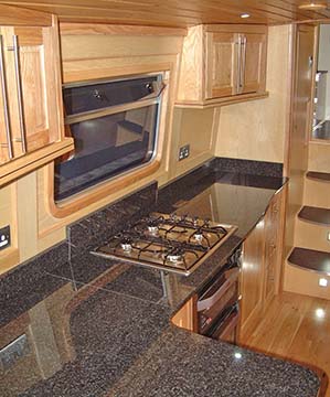Moder narrowboat by Syenson Boatbuilders with washing machine, fridge, mechanized corner systems, solid surface worktop and under mount sink