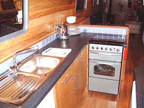 Typical crossover style galley with laminate work surfaces on Stenson narrowboat