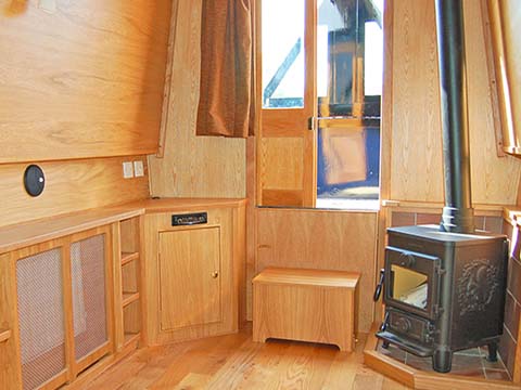 Traditional style forward saloon with solid fuel stove
